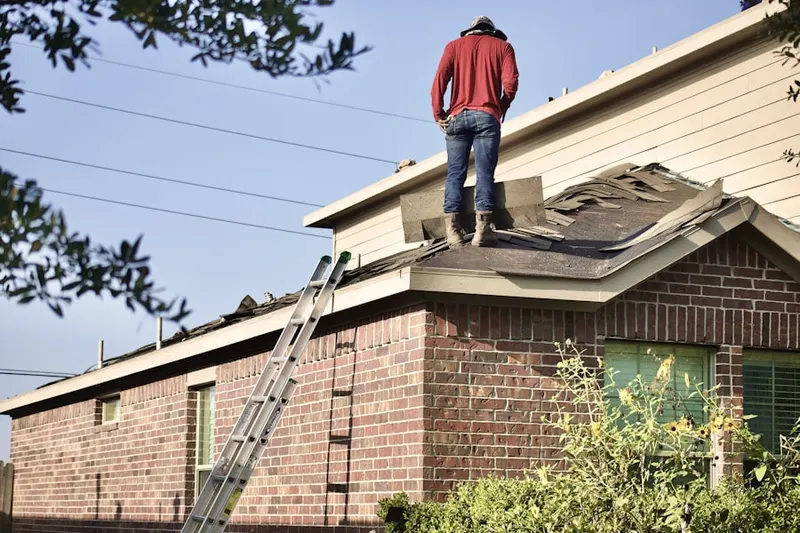 Professional roofer working on a residential roof in Hayden Run Village
